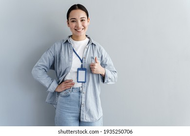 Business girl with a name tag on her neck. Isolated on a gray path. - Shutterstock ID 1935250706