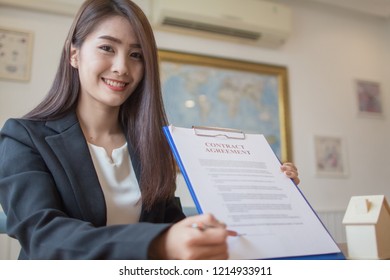 Business Girl working in the office.Businesswoman working on laptop in her workstation. - Shutterstock ID 1214933911
