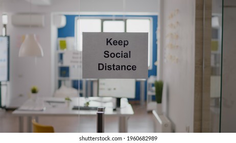 Business Glass Interior Office With Keep Social Distance Sign On The Wall. Modern Office Space With Nobody In It During Global Pandemic, Coronavirus Crisis