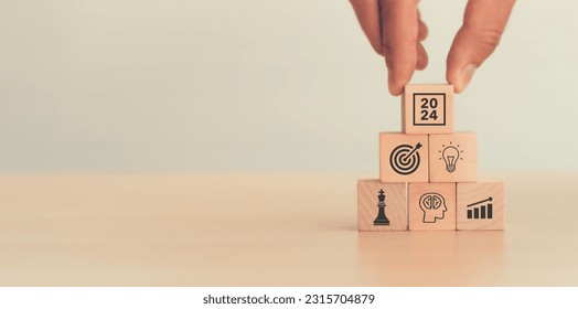 Business goal, plan, action in 2024. Wooden cubes with icon business strategies, action plan, goal, increase sale, process, game plan. Business strategies and achieving goals. Sustainable development.
