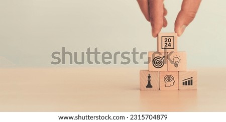 Business goal, plan, action in 2024. Wooden cubes with icon business strategies, action plan, goal, increase sale, process, game plan. Business strategies and achieving goals. Sustainable development.