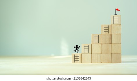 Business goal success concept. Rises up stairs to goal and achieve business success.Personal growth. Initiation for planning to reach target. Flag target aim icon on wooden cubes with grey background. - Shutterstock ID 2138642843