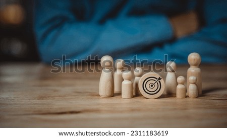 Business goals concept, young man thinking business goals, wooden dummy representing a group of people who need work goals to achieve, business goals, human resource management