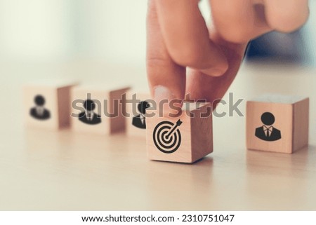 Business goals and corporate team building concept. Strategy and goals achievement. Wooden cube with goals, target icon on grey background. Project planning, common goals, vision, mission, strategies.