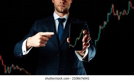 Business graph. Businessman holding finance application for sell, buy and analysis profit dividend statistics. Investment business technology app on digital screen. Shares stockmarket background