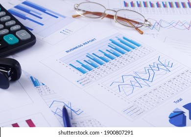 Business Graph, Report, Calculator, Pen And Glasses