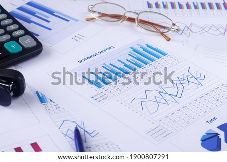 business graph, report, calculator, pen and glasses