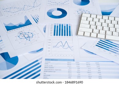Business graphs and charts report with keyboard on desk of financial advisor. Financial abstract concepts.