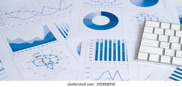 Business graphs and charts report with keyboard computer on desk of financial advisor. Financial abstract concepts.