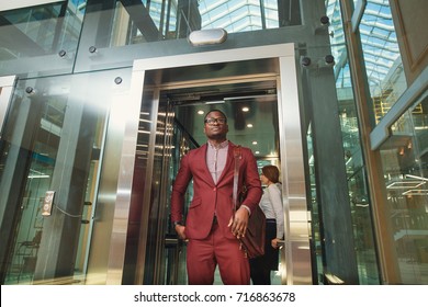 business group comes out from glass Elevator