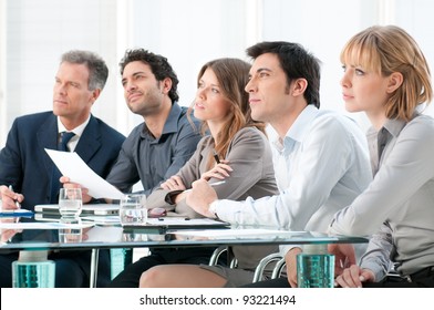 Business Group Of People Attending And Listening At Conference