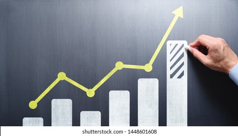 Business growth analysis and advice concept. Consultant drawing bar chart and line graph on chalkboard.
