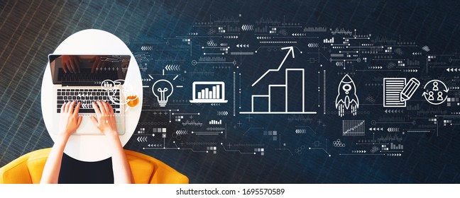 Business growth analysis with person using a laptop on a white table - Shutterstock ID 1695570589
