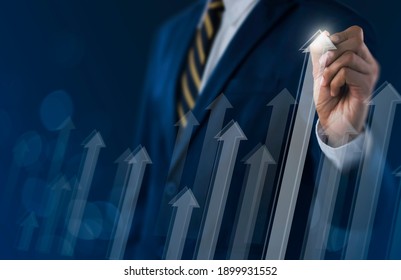 Business Growth, Boost Up Business, Progress In Business Or Success Concept. Businessman Is Drawing Raising Arrow Graph On Dark Tone Background.