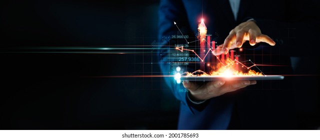 Business growth. Businessman holding tablet and a hot of fire glowing upright arrow with analyzing data and economic growth graph. Strategy. Stock market. Financial and banking. Digital marketing. 