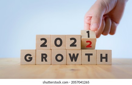Business growth concept in 2022  for business plan and strategy. Hand flips wooden cubes "2021" to "2022" text  on beautiful  background and copy space. Banner for the new action plan ,annual plan.  - Shutterstock ID 2057041265