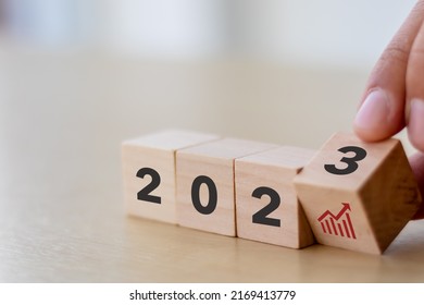 Business growth concept in 2023. Business goals and achievement. Sustainable development. Wooden cubes inscripted 2023 and growth icon on smart background. Positive indicators banner. - Shutterstock ID 2169413779