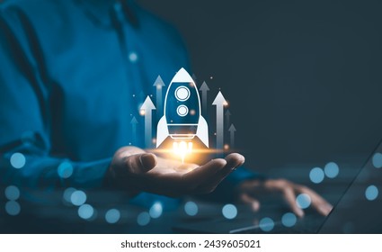 Business growth concept. Professional businessman projecting a holographic rocket symbolizing startup success and growth acceleration. Rising earnings, increasing financial profits, Wealth fast, - Powered by Shutterstock