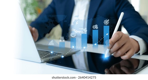 Business growth strategy concept. A professional uses a digital tablet to interact with blue bar graphs and business strategies icons; teamwork, innovation, business collaboration, sustainability.