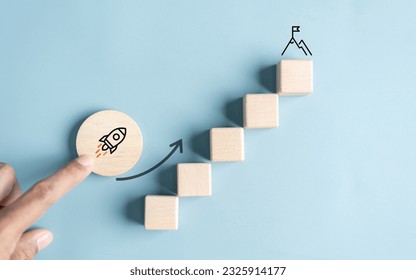 Business growth success achievement concept; hand of people arranging as step stair or ladder rocketship launch for planning development leadership and customer target group concept. - Shutterstock ID 2325914177