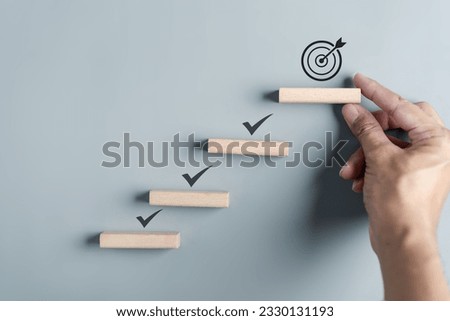 Business growth success achievement concept, hand arranging wooden block stacking as step stair or ladder for planning development leadership and customer target group concept.