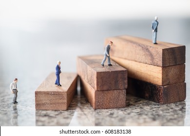 Business, growth and Succession concept. Group of businessman miniature figures walking and standing on wood stair made from wooden blocks toy. - Shutterstock ID 608183138