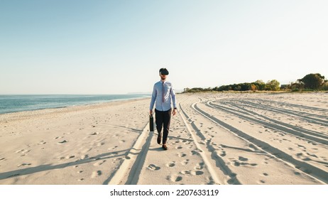 Business Guy Walks At The Beach With Virtual Reality Glasses