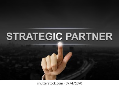 Business Hand Clicking Strategic Partner Button On Black Blurred Background