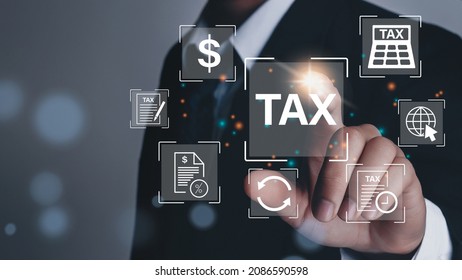 Business hand clicks virtual screen to tax return online for tax payment by corporations such as VAT, income tax, and property tax.  - Shutterstock ID 2086590598
