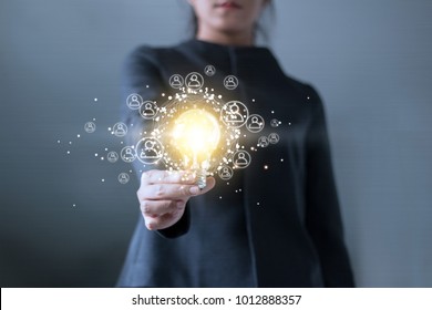 Business Hand Holding Light Bulb And Global Networking Connection With Icons On Virtual Screen Background. Innovation And Social Network Concept
