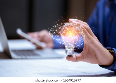 Business Hand Holding Light Bulb,with Brain Icon,creativity And Innovative Are Keys To Success,new Ideas And Innovation Concept.