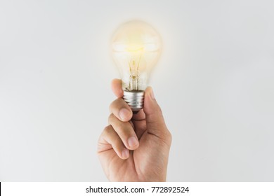 business hand holding lightbulb. concept for new ideas with innovation and creativity. - Shutterstock ID 772892524
