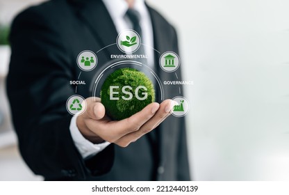 Business Hand Of Human Holding Green Earth ESG Icon For  Environmental, Social And Governance For Sustainable Organizational Development. ​account The Environment, Society And Corporate Governance