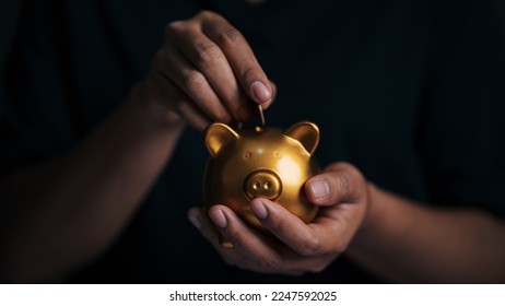 Business hand protecting and saving gold piggy bank, Stock funding or money saving. financial investment concept, Stack of the gold,  money and gold financial planning concept - Shutterstock ID 2247592025