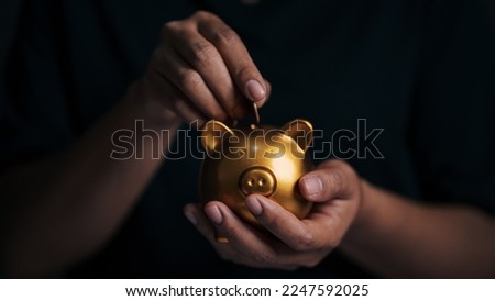 Business hand protecting and saving gold piggy bank, Stock funding or money saving. financial investment concept, Stack of the gold,  money and gold financial planning concept