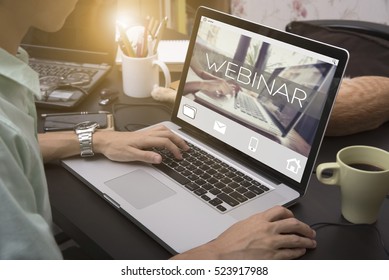 business hand typing on a laptop keyboard with Webinar homepage on the computer screen learning internet website web page concept. - Shutterstock ID 523917988