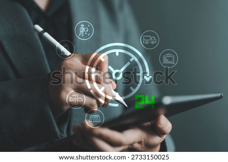 Business hand using digital tablet with glowing 24 hour delivery logistics. Concept of fast, real-time delivery, shipping, transportation, supply chain and warehouse automation management systems.