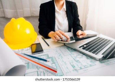 business  hand working and laptop with on on architectural project at construction site at office desk in office