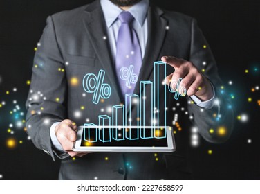 Business hands hold digital tablet with infographic chart. - Shutterstock ID 2227658599