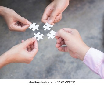 Business hands holding puzzle teamwork concept - Shutterstock ID 1196732236