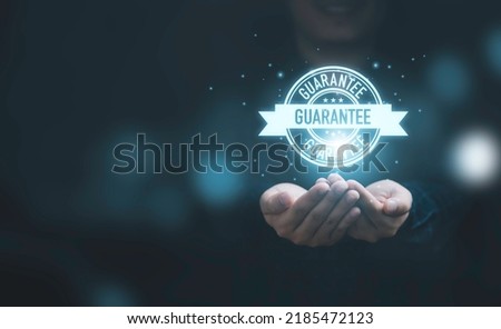 Business hands showing virtual guarantee tag label for giving the best quality of product and service to customer concept.