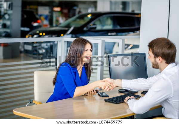 Business handshake. Happy\
Business woman and sales manager shaking hands, finishing up\
conversation