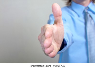 Business Handshake, Let's Make A Deal. Businessman In Blue Shirt Offering A Handshake.