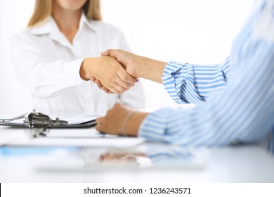 Business handshake at meeting or negotiation in office. Partners shaking hands while satisfied because signing contract or financial papers. Best client service, casual style. Success concept - Shutterstock ID 1236243571