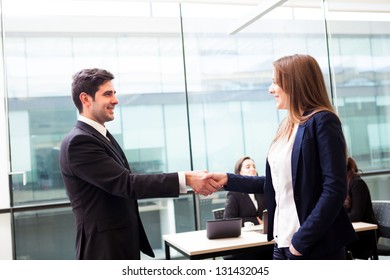 Business Handshake At Modern Office With Bussiness People On Background