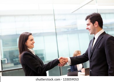 Business Handshake At Modern Office With Bussiness People On Background