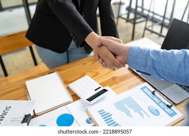 Business Handshake In The Office Meeting, Financing Accounting Concept. Businessman Investment Consultant Analyzing Company Financial Report Balance Sheet Statement Working With Digital Graphs.	

