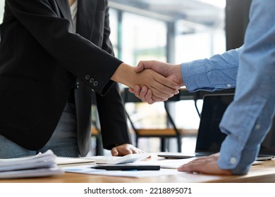 Business Handshake In The Office Meeting, Financing Accounting Concept. Businessman Investment Consultant Analyzing Company Financial Report Balance Sheet Statement Working With Digital Graphs.	

