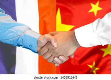 Business Handshake On The Background Of Two Flags. Men Handshake On The Background Of The France And China Flag. Support Concept