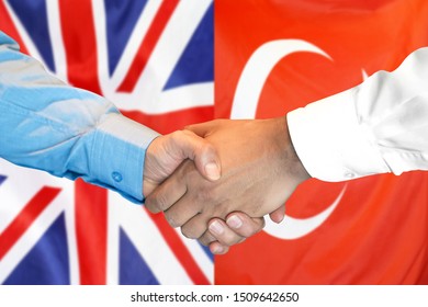 Business Handshake On The Background Of Two Flags. Men Handshake On The Background Of The Turkey And United Kingdom Flag. Support Concept